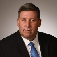 John P. Woods, Vice President & DHS Client Executive, CACI International, Inc.