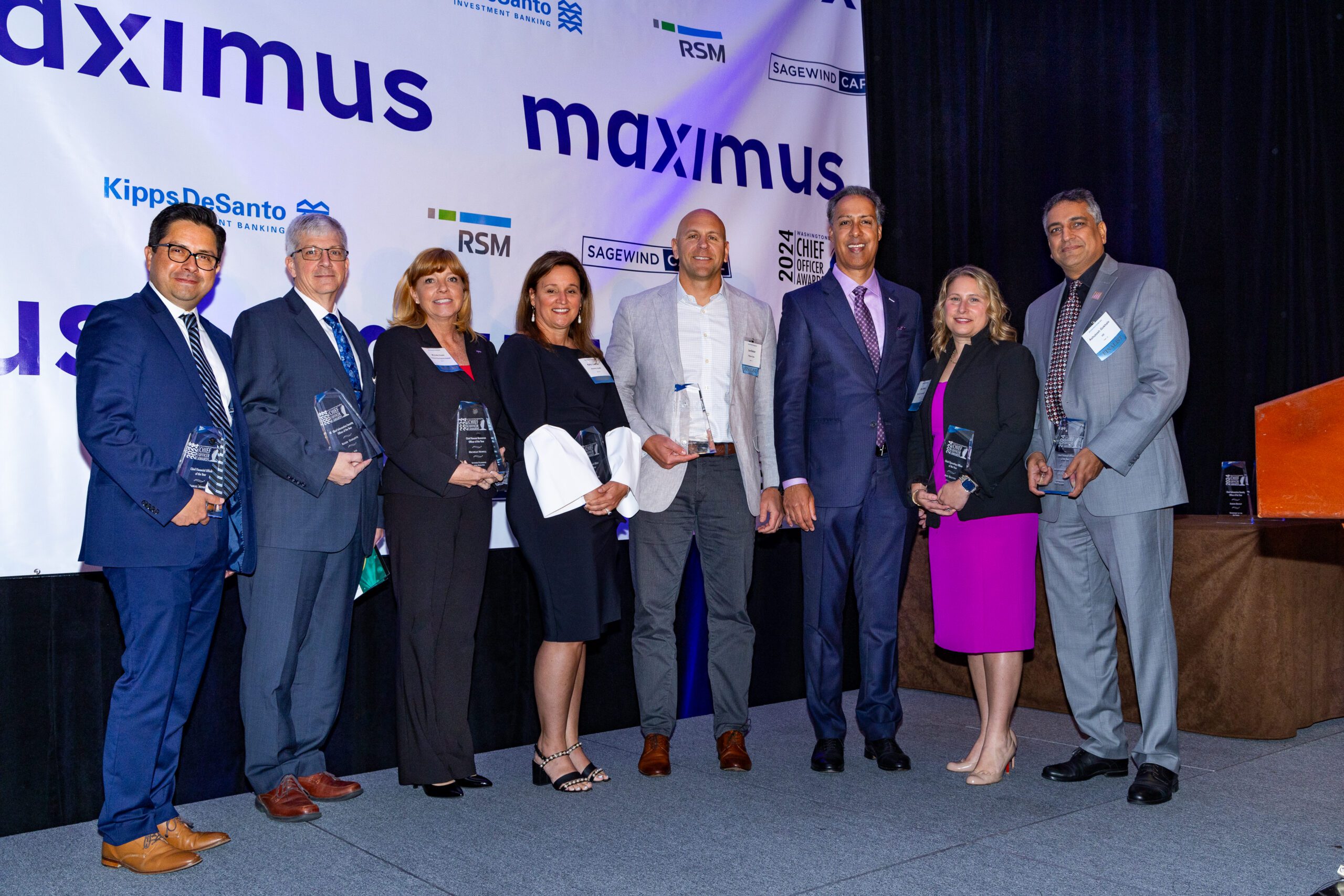 WashingtonExec CEO JD Kathuria stands with some of the winners of the 2024 Chief Officer Awards. (From left to right: Integral Federal's Manuel Mendez, V2X's Roger Ouellette, SPA's Michelle Howell, Acentra Health's Kelly Loeffler, Royce Geo's Lee Bader, JD Kathuria, Two Six Technologies' Amy Dalton and HII's Ashutosh Gokhale.)